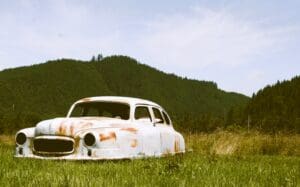 A car that is sitting in the grass.