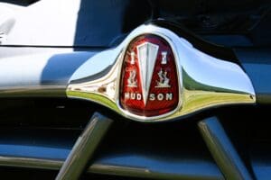 A close up of the hood ornament on an old car.